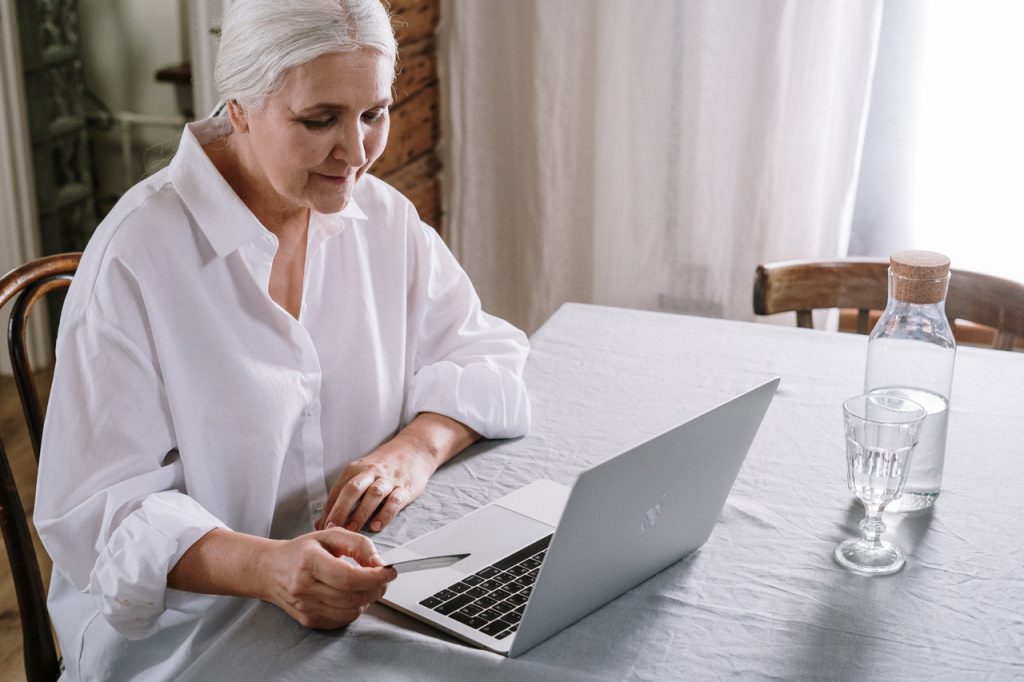 Older lady using a laptop to do online shopping