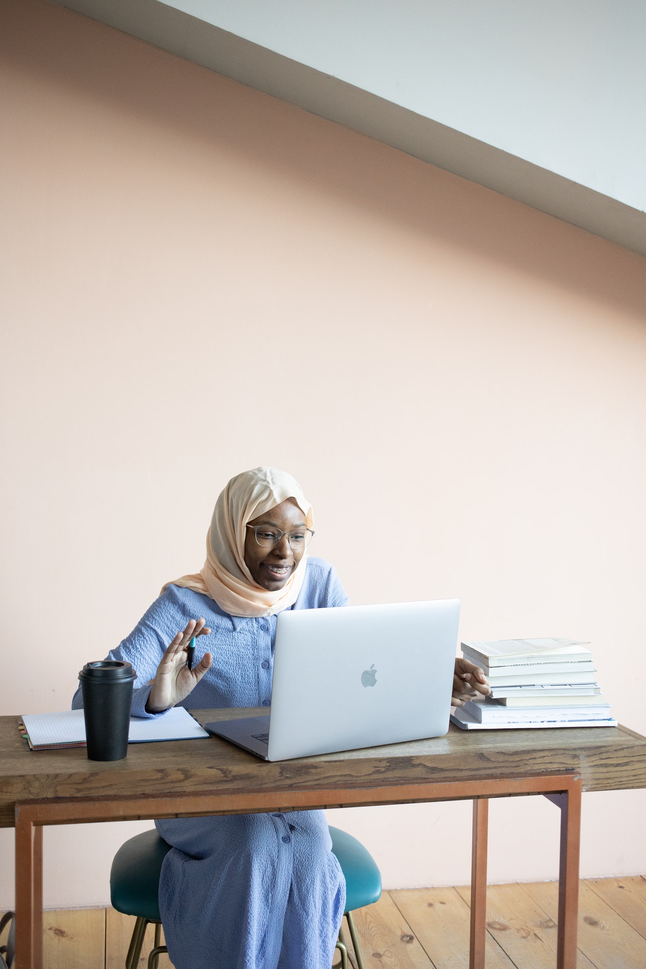 Younger woman working on a laptop outside