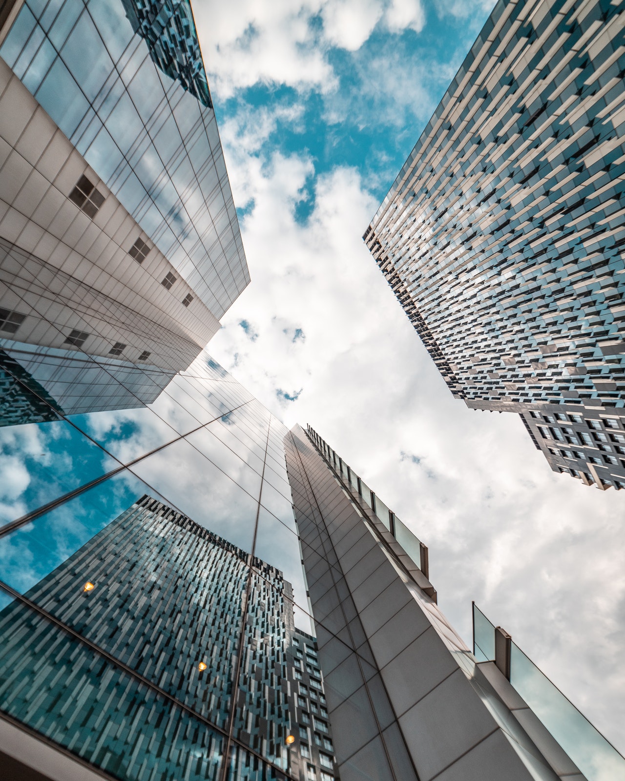 Looking up at the sky past high rise buildings